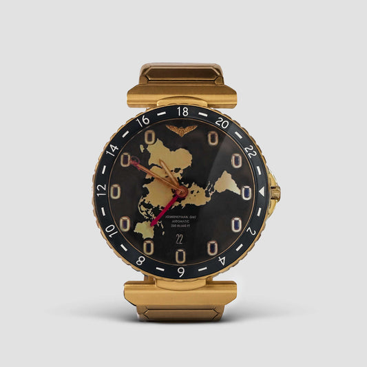 Journeyman GMT watch with world map dial, red GMT hand, brushed gold finish, and 43mm automatic case
